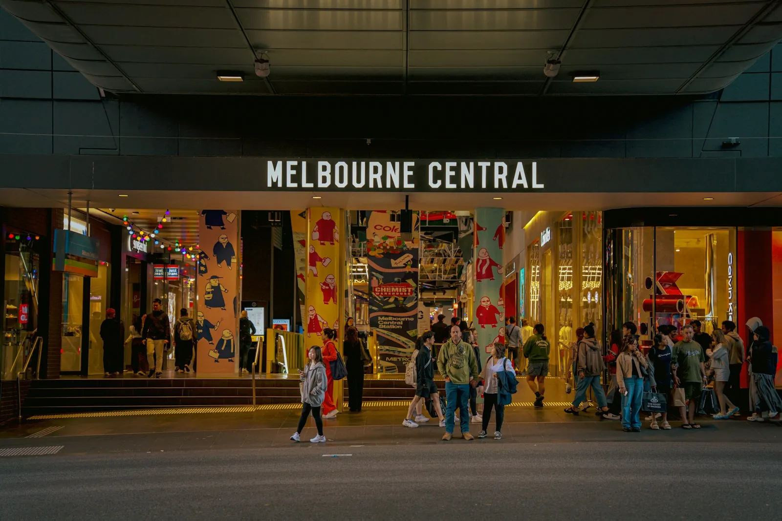 People crossing a busy street in Melbourne, Australia, in golden light