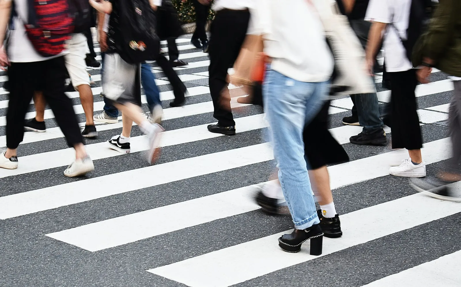 Crowds of people walking across a street crossing in Tokyo