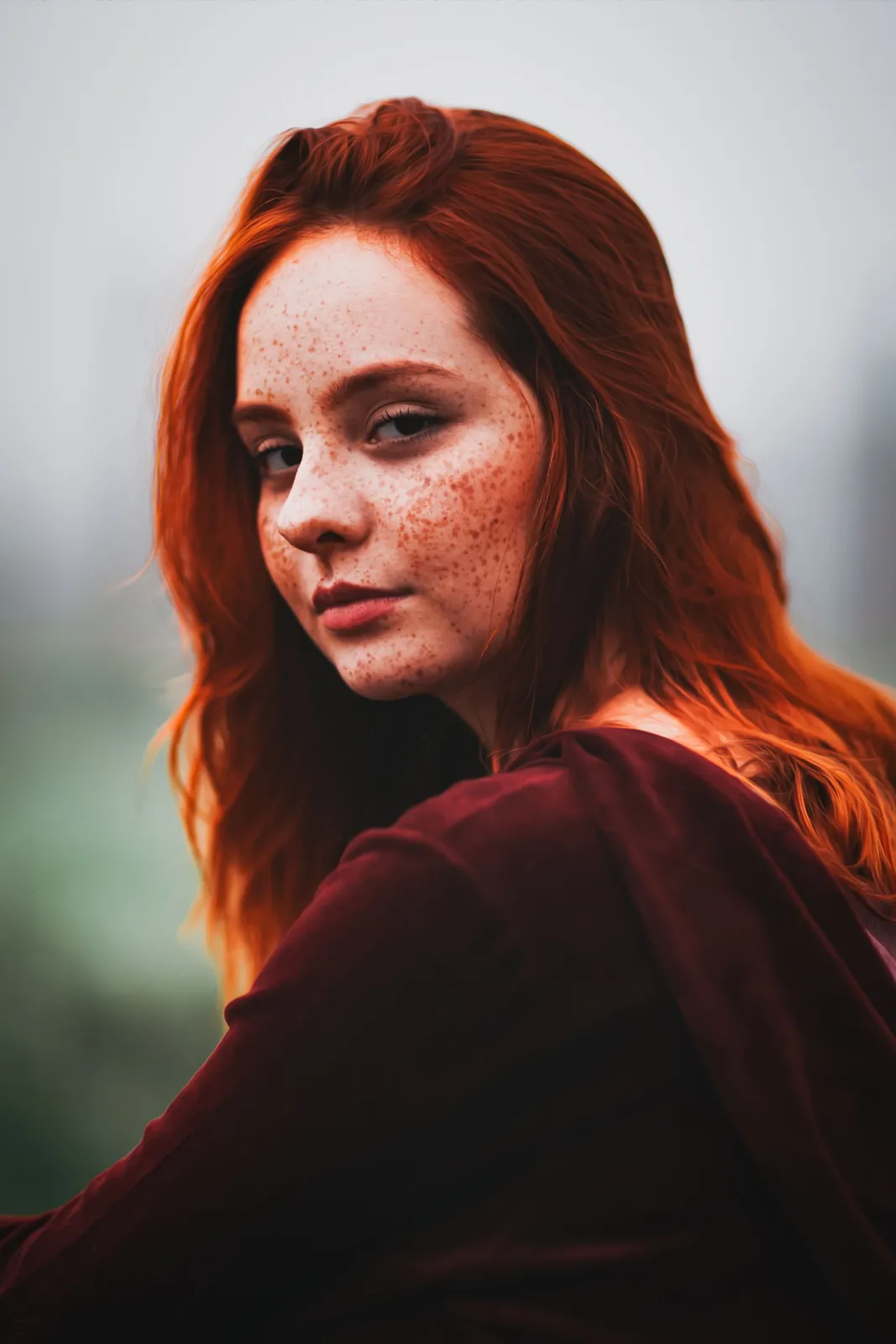 A woman with red hair and freckles