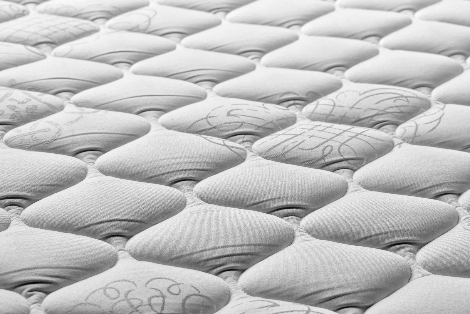 Close-up of the soft, quilted top of a white mattress
