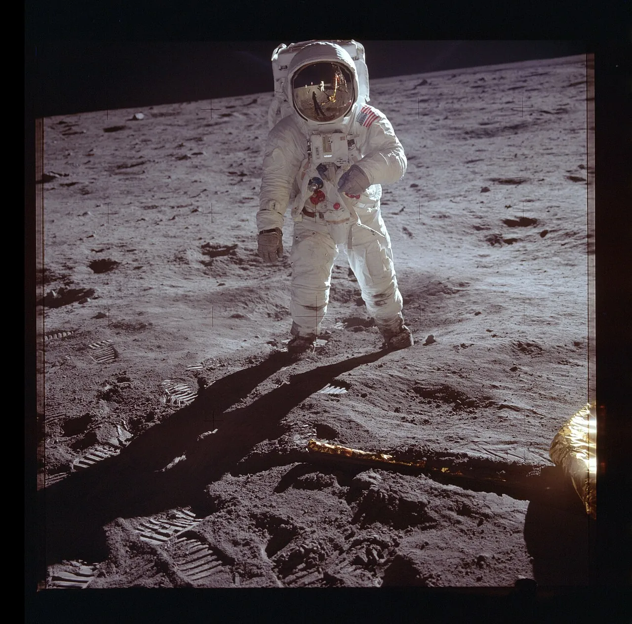 Astronaut Buzz Aldrin in his white spacesuit standing on the Moon during Apollo 11