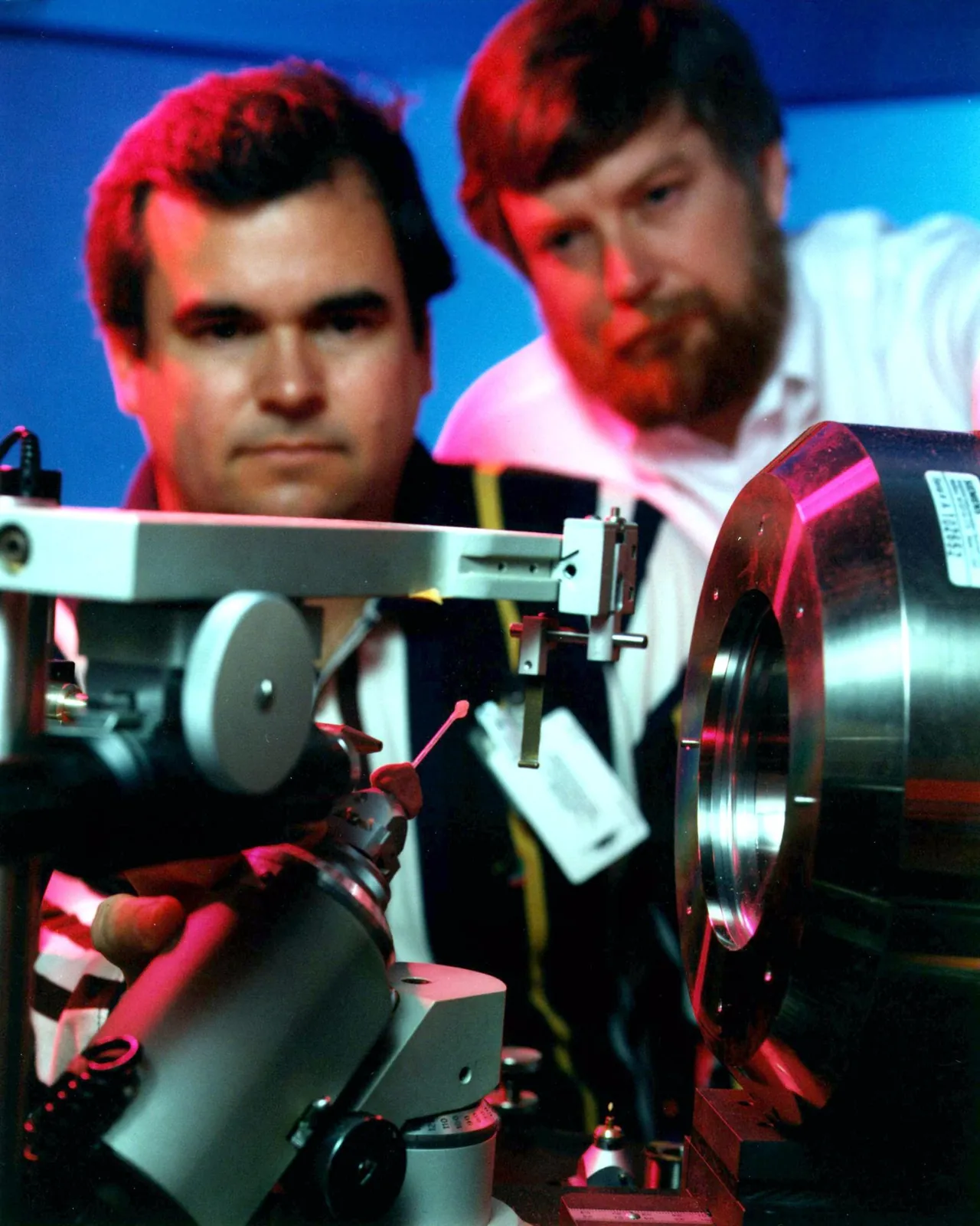 Two scientists line up a lysozyme crystal, a protein from egg whites, for an X-ray study