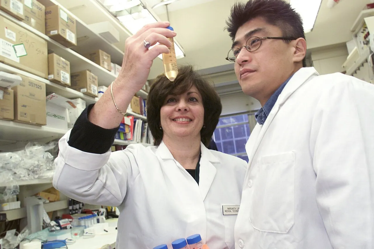 Two scientists examining a vial in a National Cancer Institute lab
