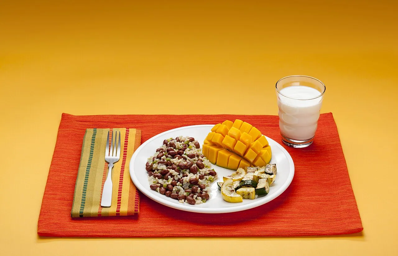 A dinner of brown rice, beans, squash, mango and milk