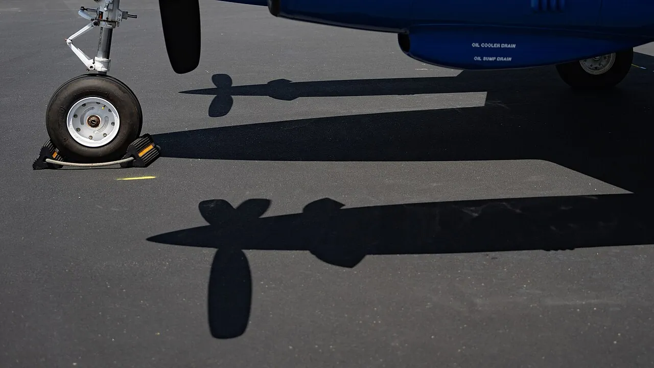 A twin-propeller plane fitted with chutes for releasing sterile screwworm flies, flying back to its base in Edinburg, Texas