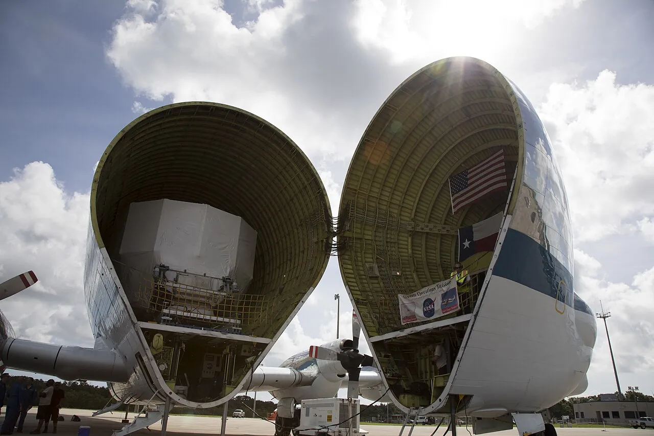 A large Orion test module sits snug inside the Super Guppy's open cargo bay at Kennedy Space Center