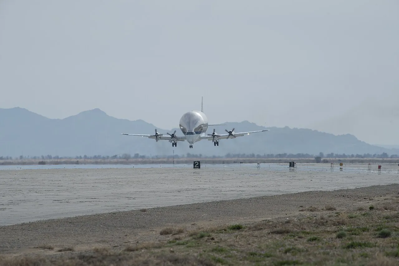 The Super Guppy lands on a desert runway in Palmdale, California