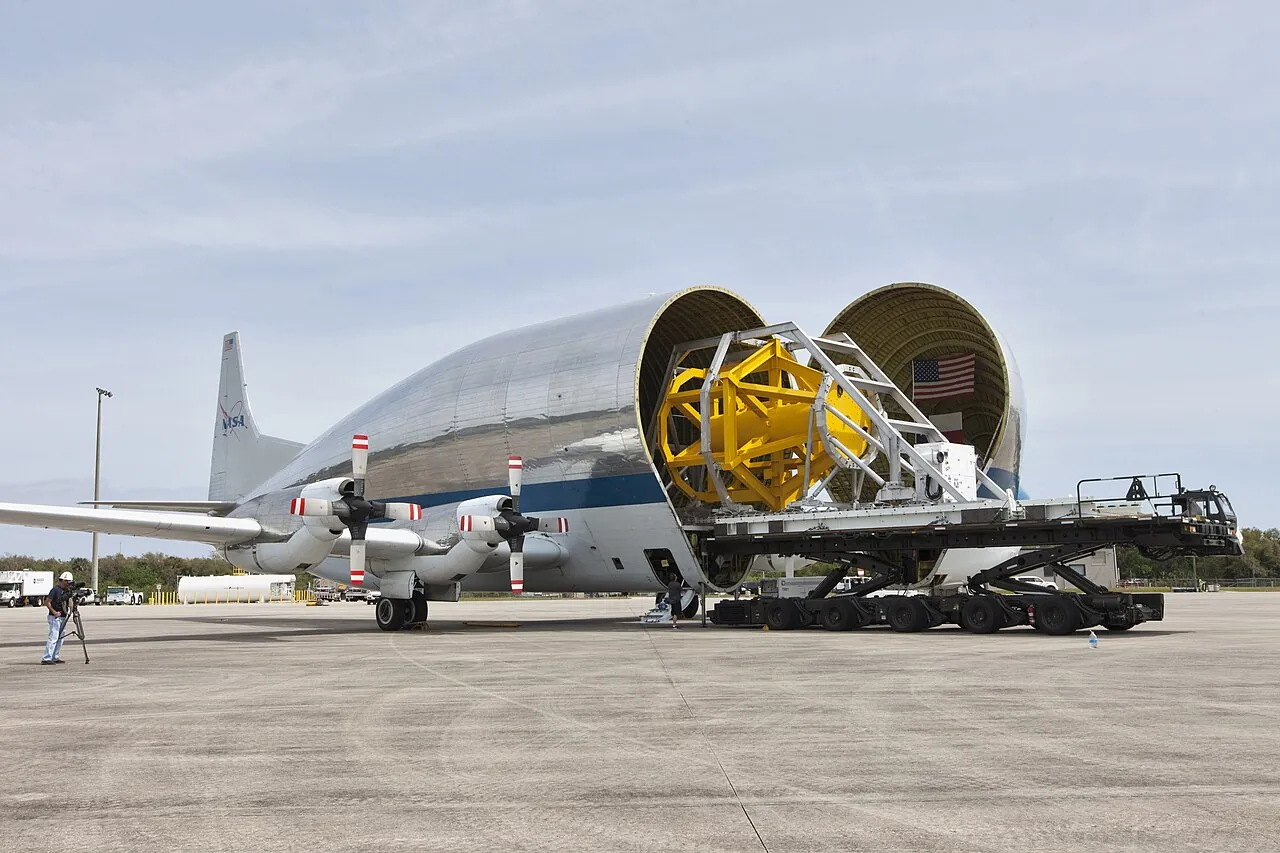 A transporter for the Orion spacecraft rolls into the Super Guppy's cargo bay during a fit check at Kennedy Space Center