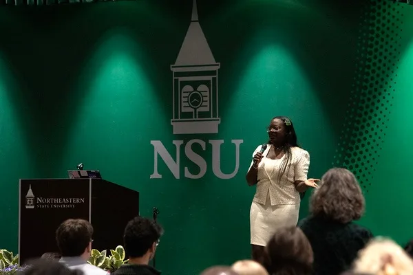 Dr. Raven speaking to a full auditorium
