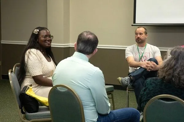 Dr. Raven talking with a small group in a workshop